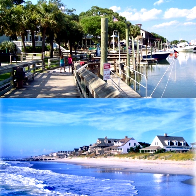 Boardwalk marina with boats and beachfront houses