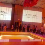 Fashion event attendees around illuminated runway