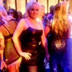 Person in black dress at crowded party