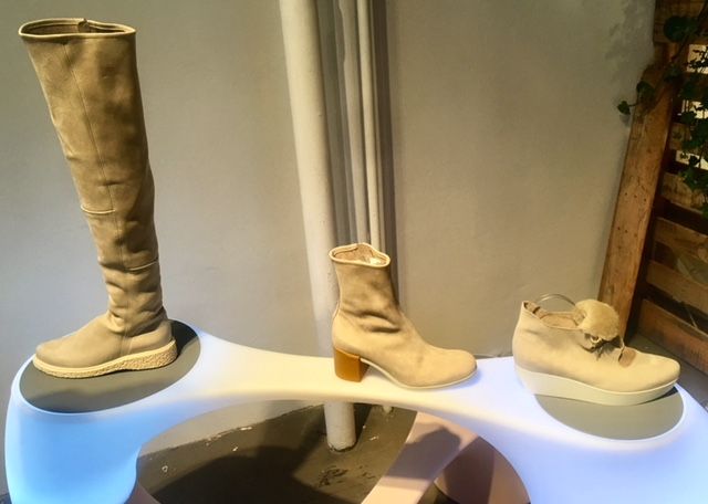 Tan women's boots and sneaker on display