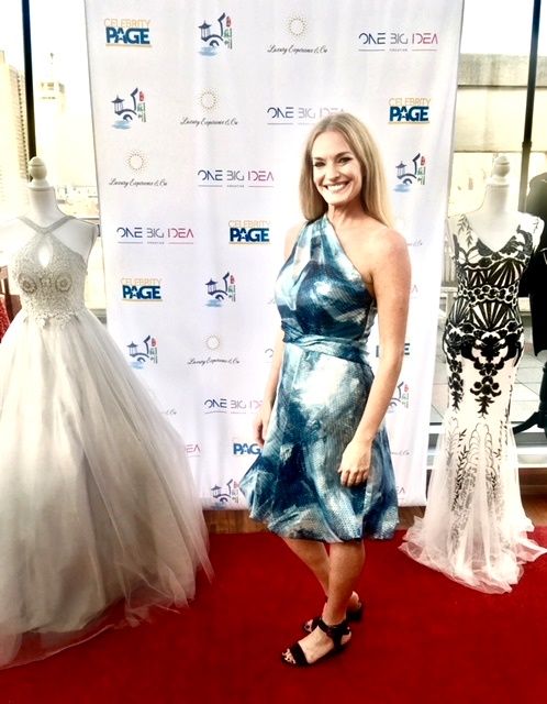 Woman in blue one-shoulder dress on red carpet