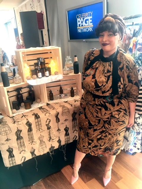 Woman standing beside skincare display at booth