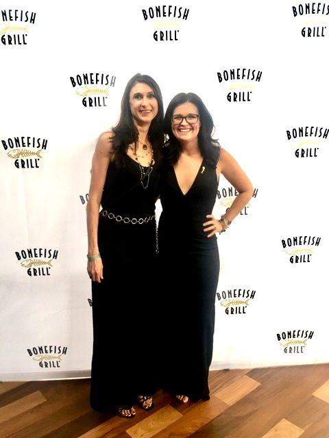 Two women in black dresses at Bonefish Grill