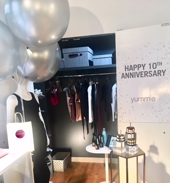 Boutique anniversary display with mannequin and balloons