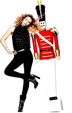 Woman leaning on giant red nutcracker soldier