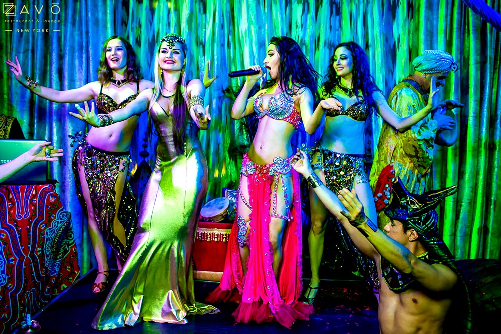 Group of belly dancers and singer on stage