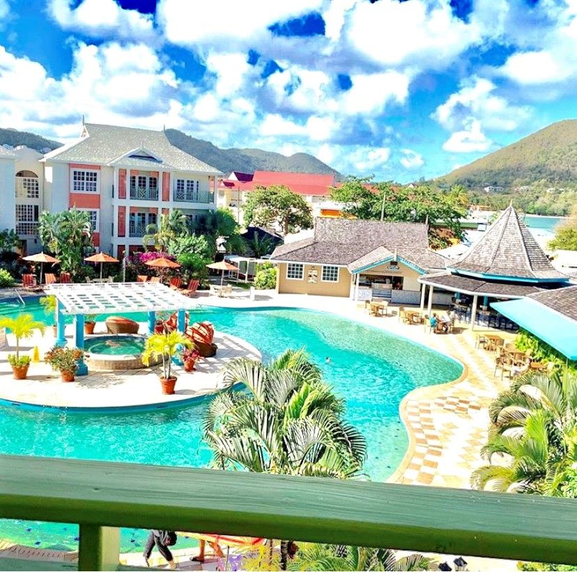 Tropical resort pool with surrounding buildings
