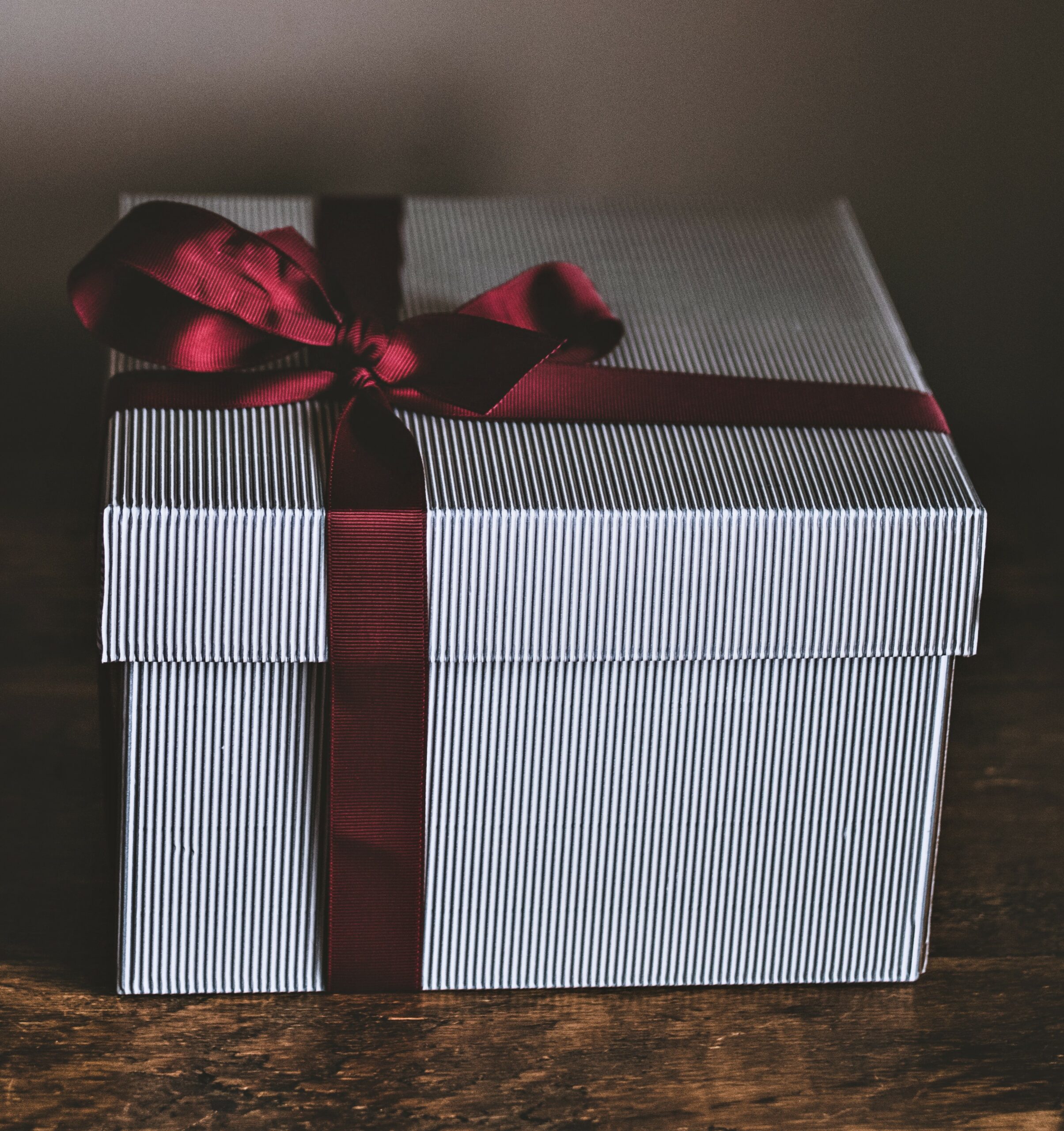 Striped gift box with red ribbon bow