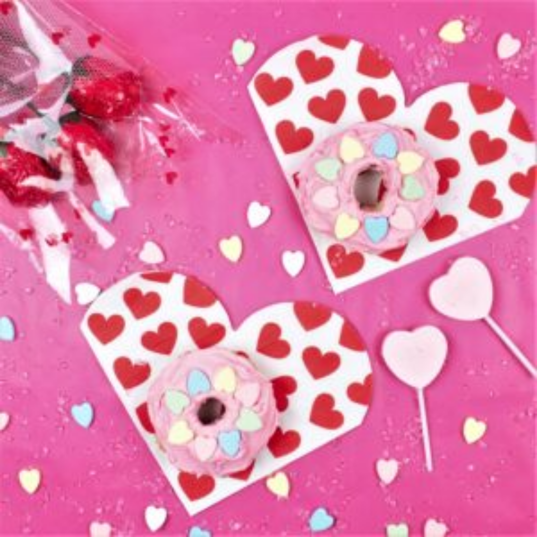 Pink heart-themed donuts and lollipops