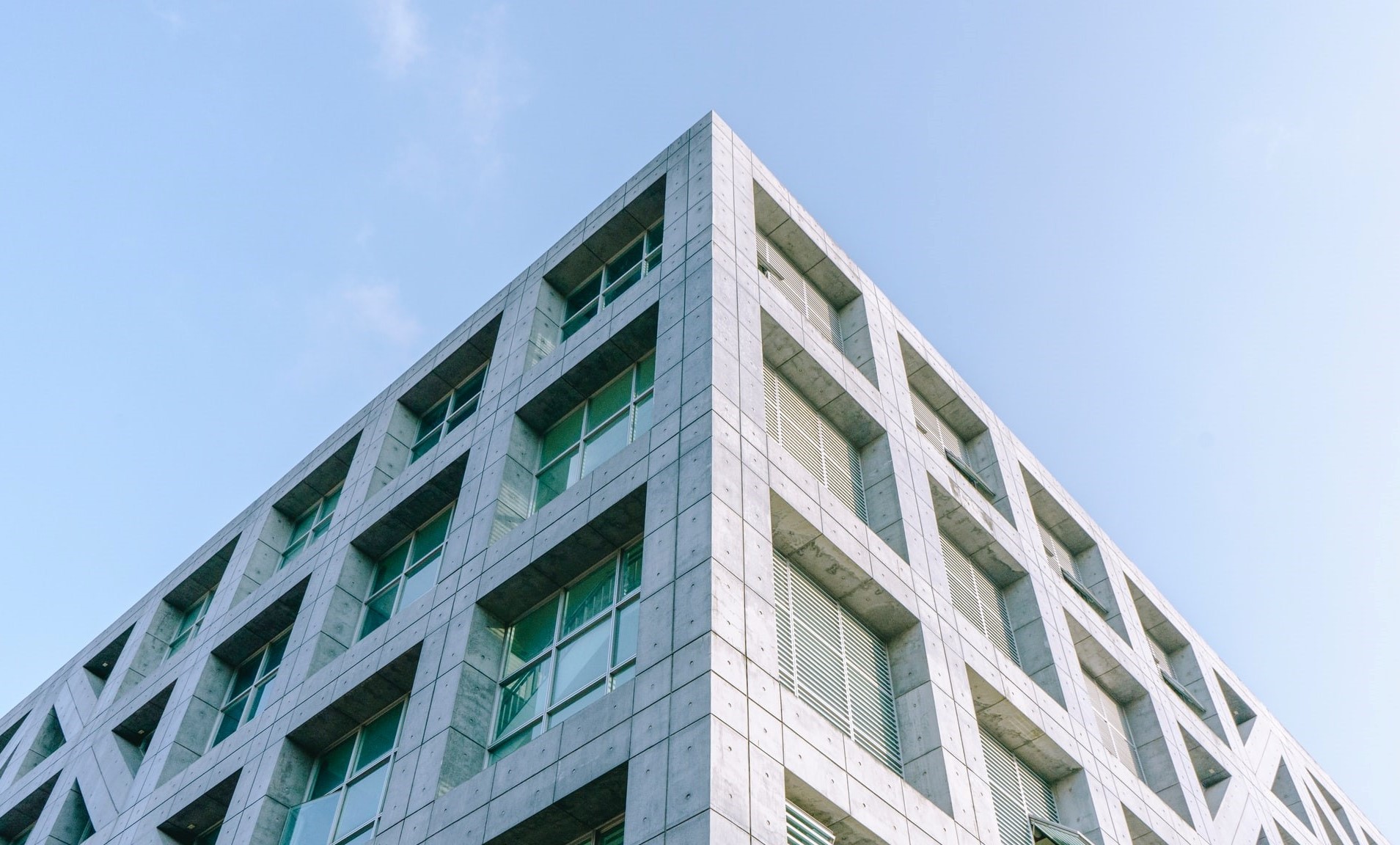 Modern concrete building corner with windows