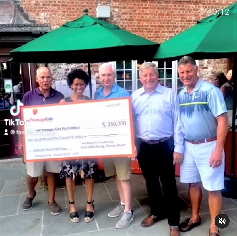 Five people holding oversized $250,000 donation check