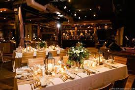 Candlelit rustic banquet table with floral centerpieces