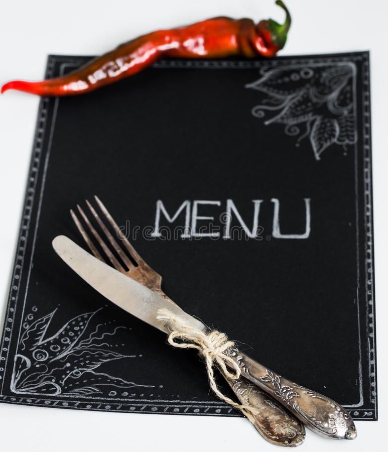 Chalkboard menu with vintage cutlery and chili