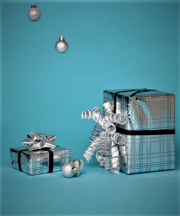 Silver wrapped gifts with bows and ornaments