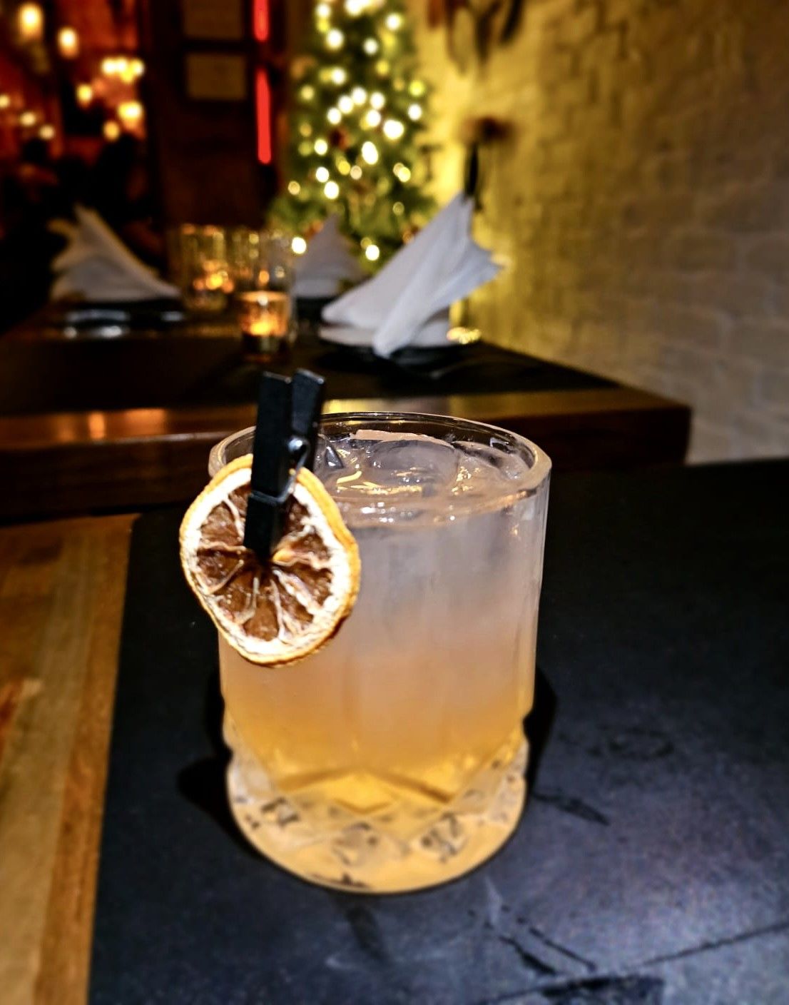 Cocktail with dried lemon garnish on table