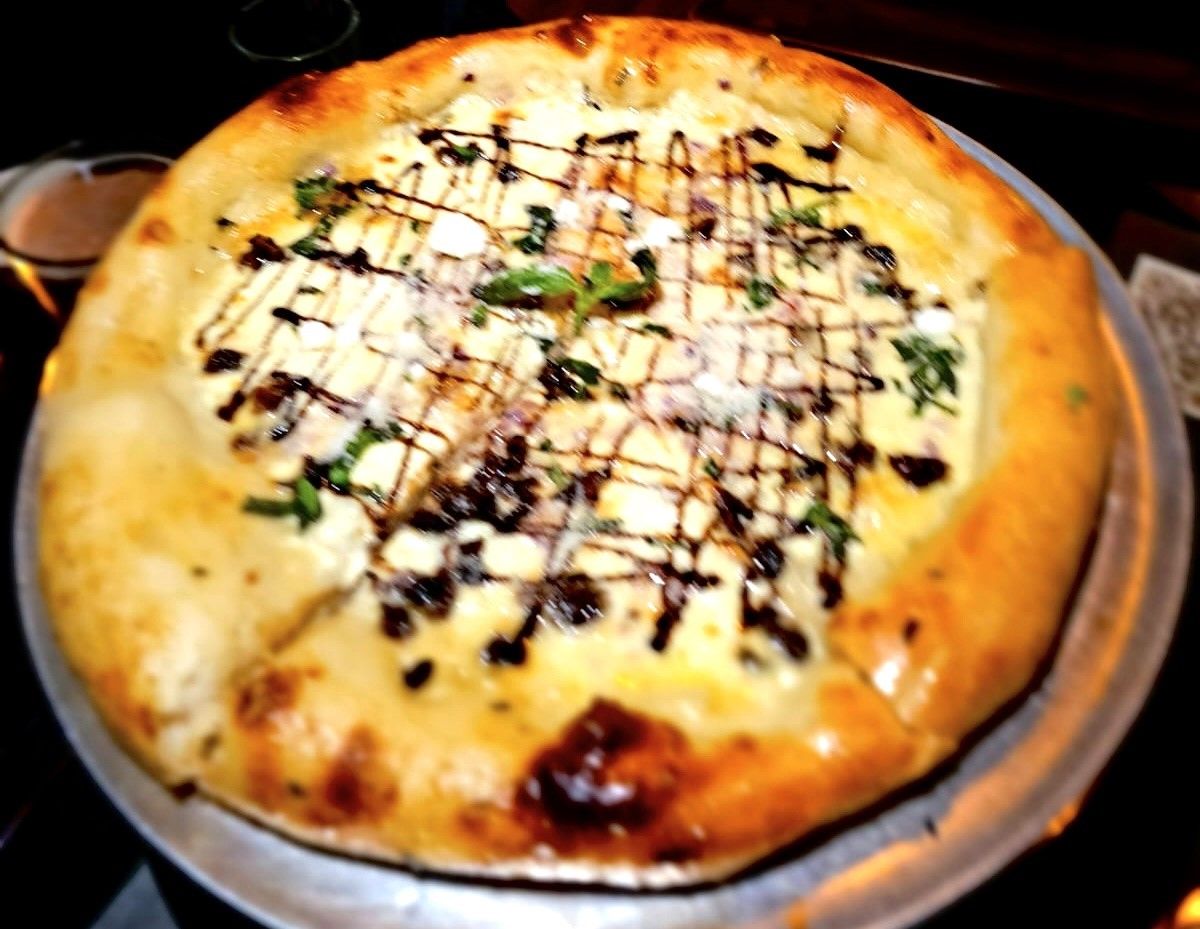 Cheesy white pizza with balsamic glaze