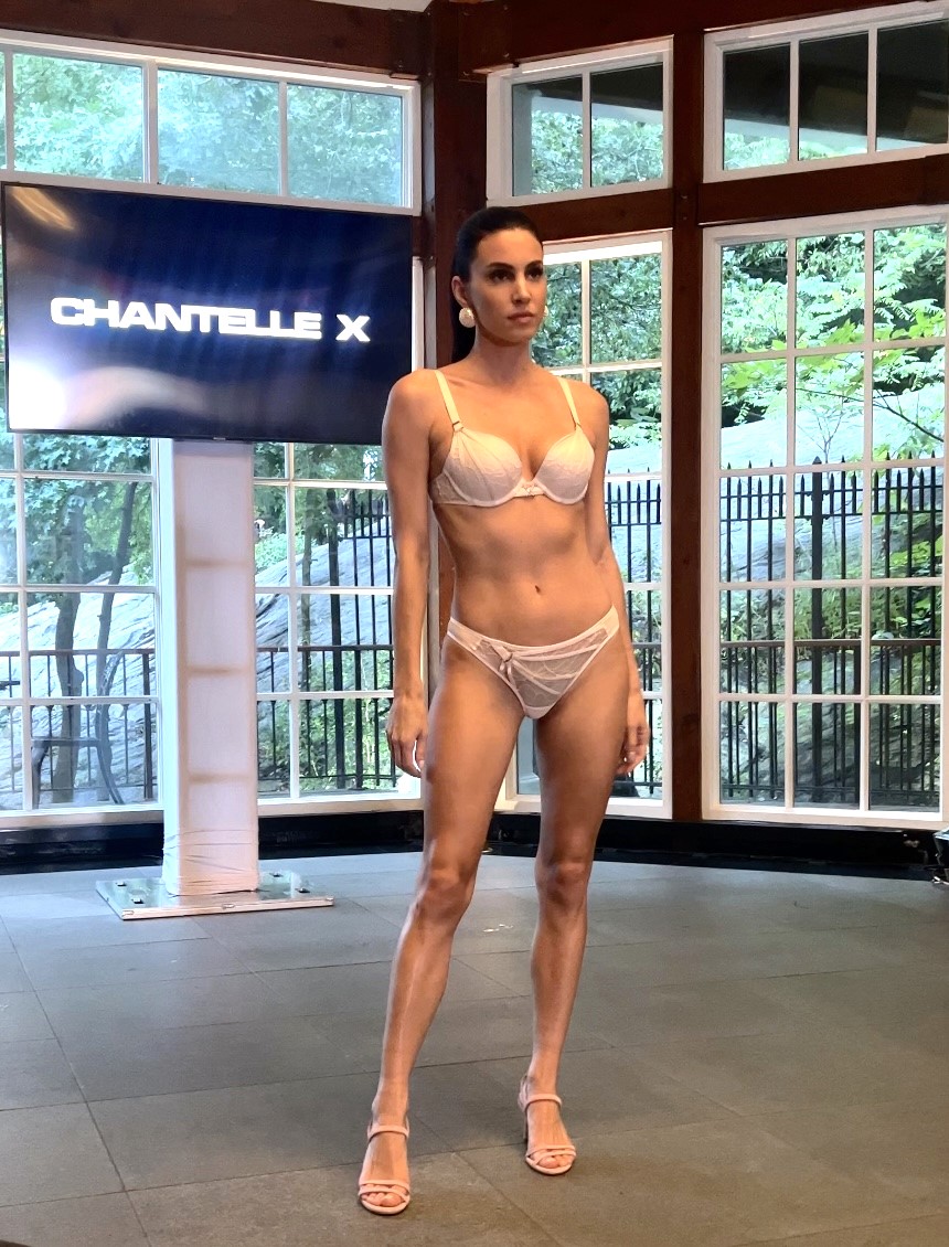 Woman modeling lingerie on indoor runway