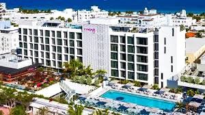 Modern beachfront hotel with pool and palm trees