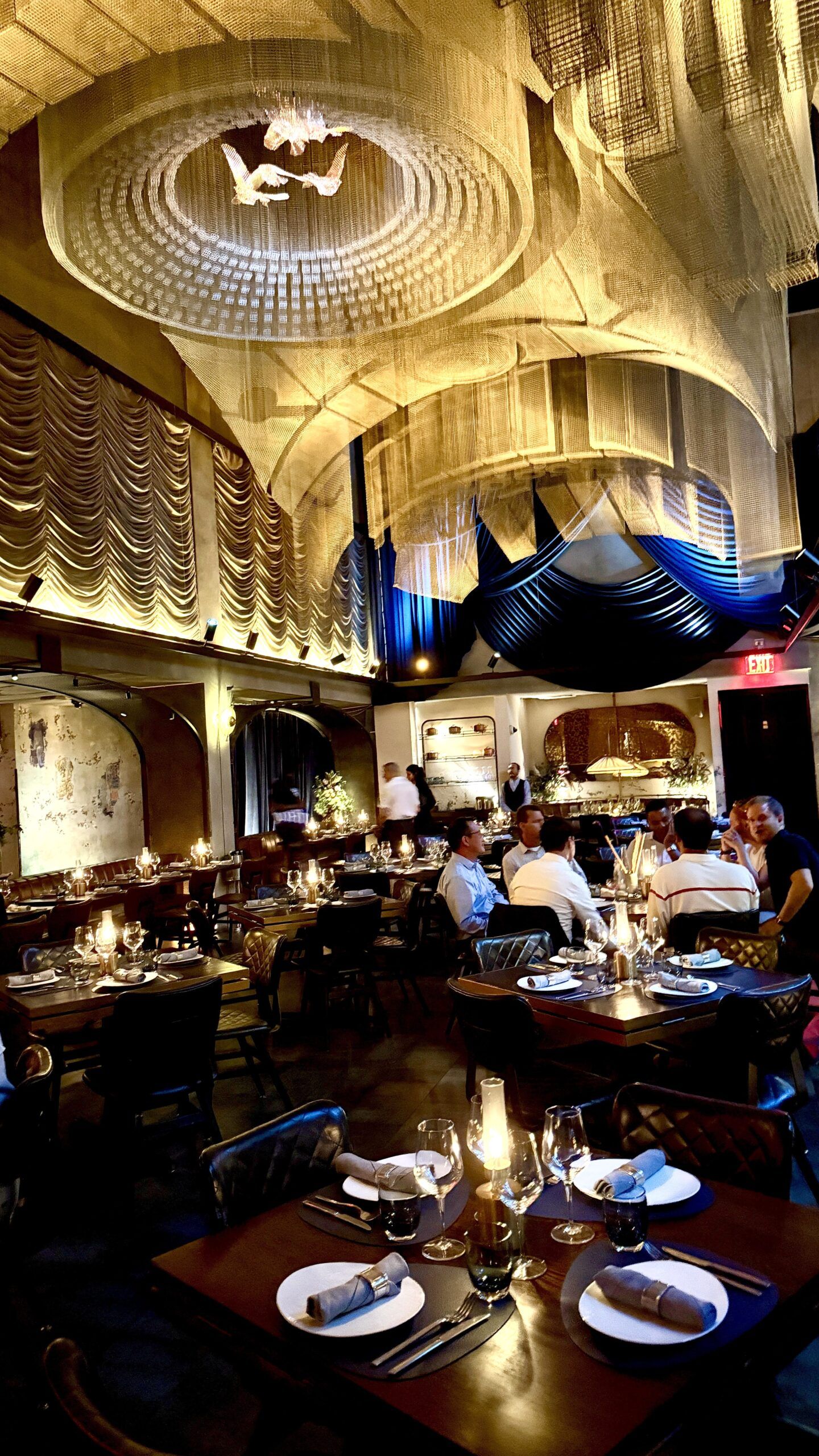 Dimly lit restaurant interior with draped ceiling