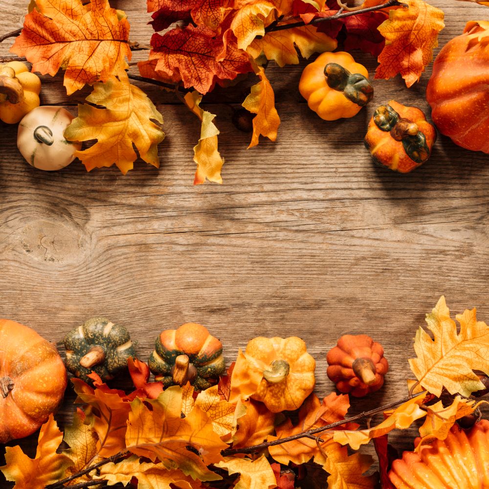 Autumn pumpkins and leaves on wooden background