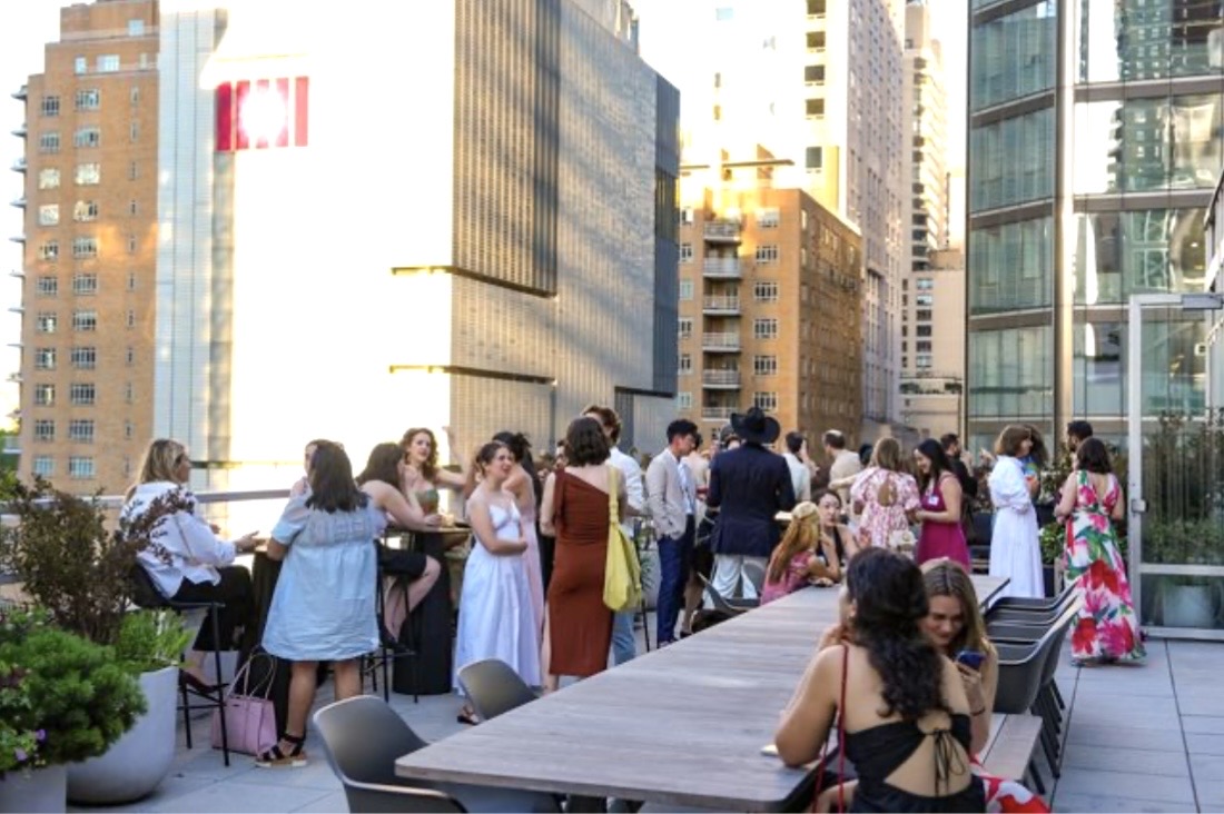 Rooftop cocktail party with city skyline
