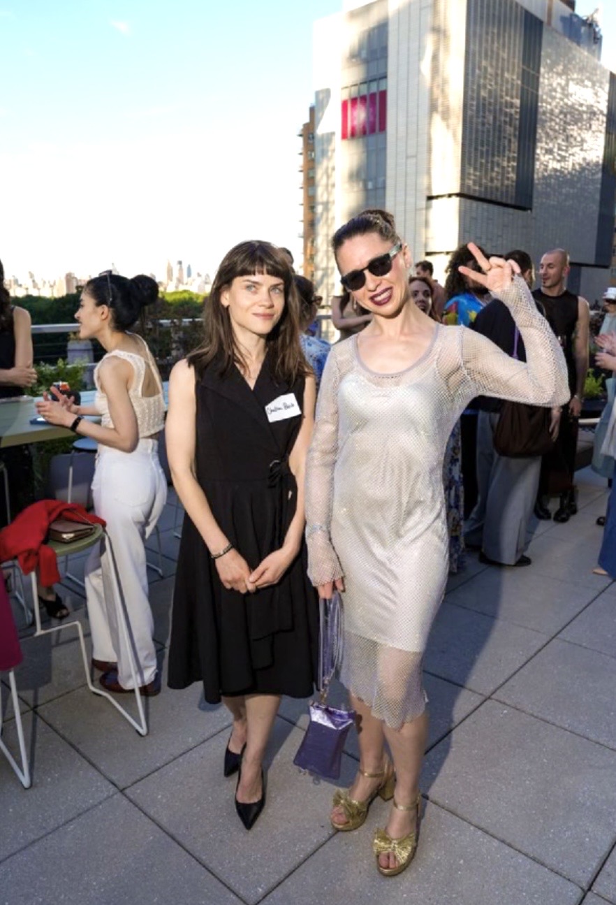 Two women posing on rooftop terrace