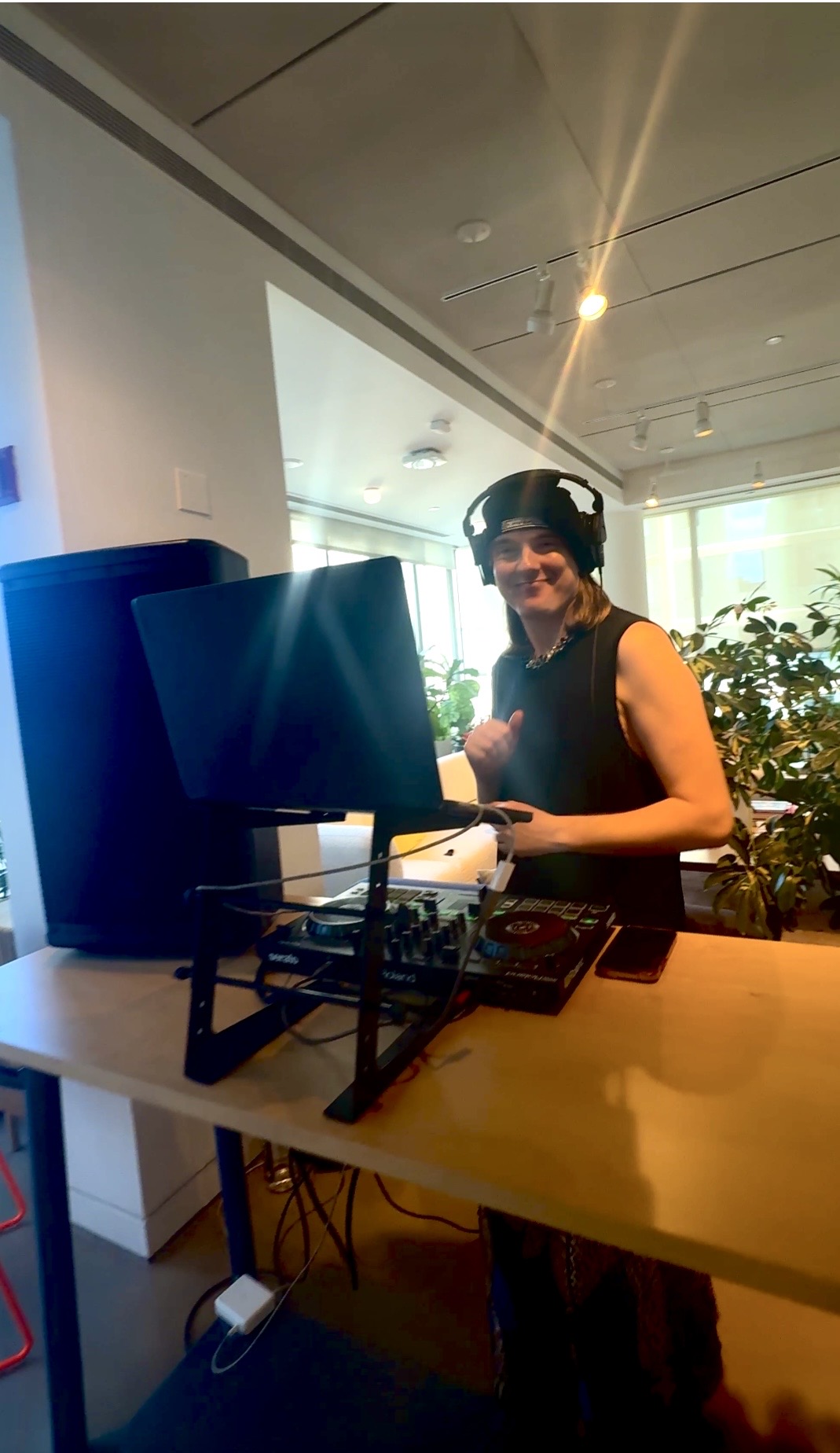 Smiling DJ with headphones at mixer
