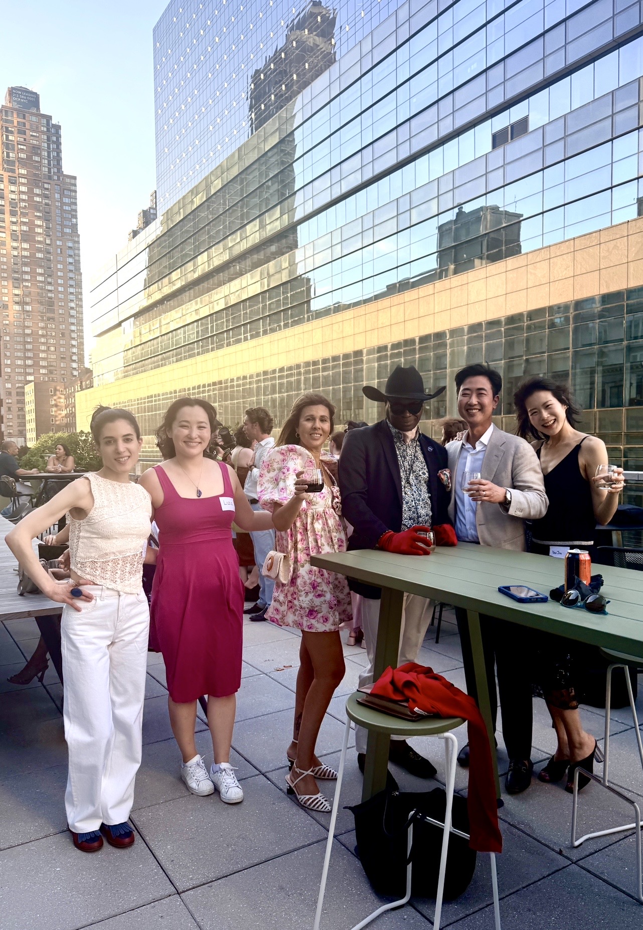 Group of friends on rooftop patio with skyline