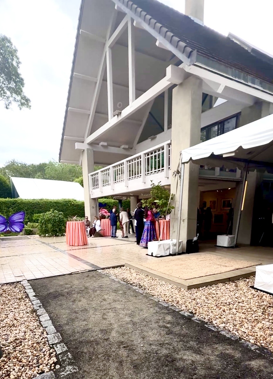 Outdoor event at modern white pavilion