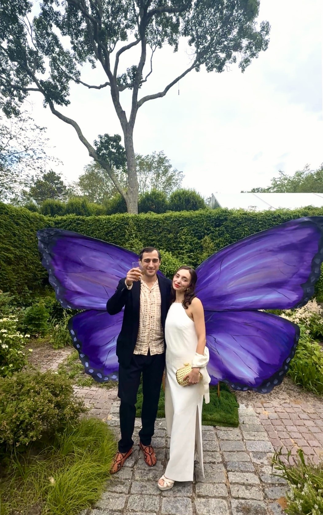Couple posing with large purple butterfly wings