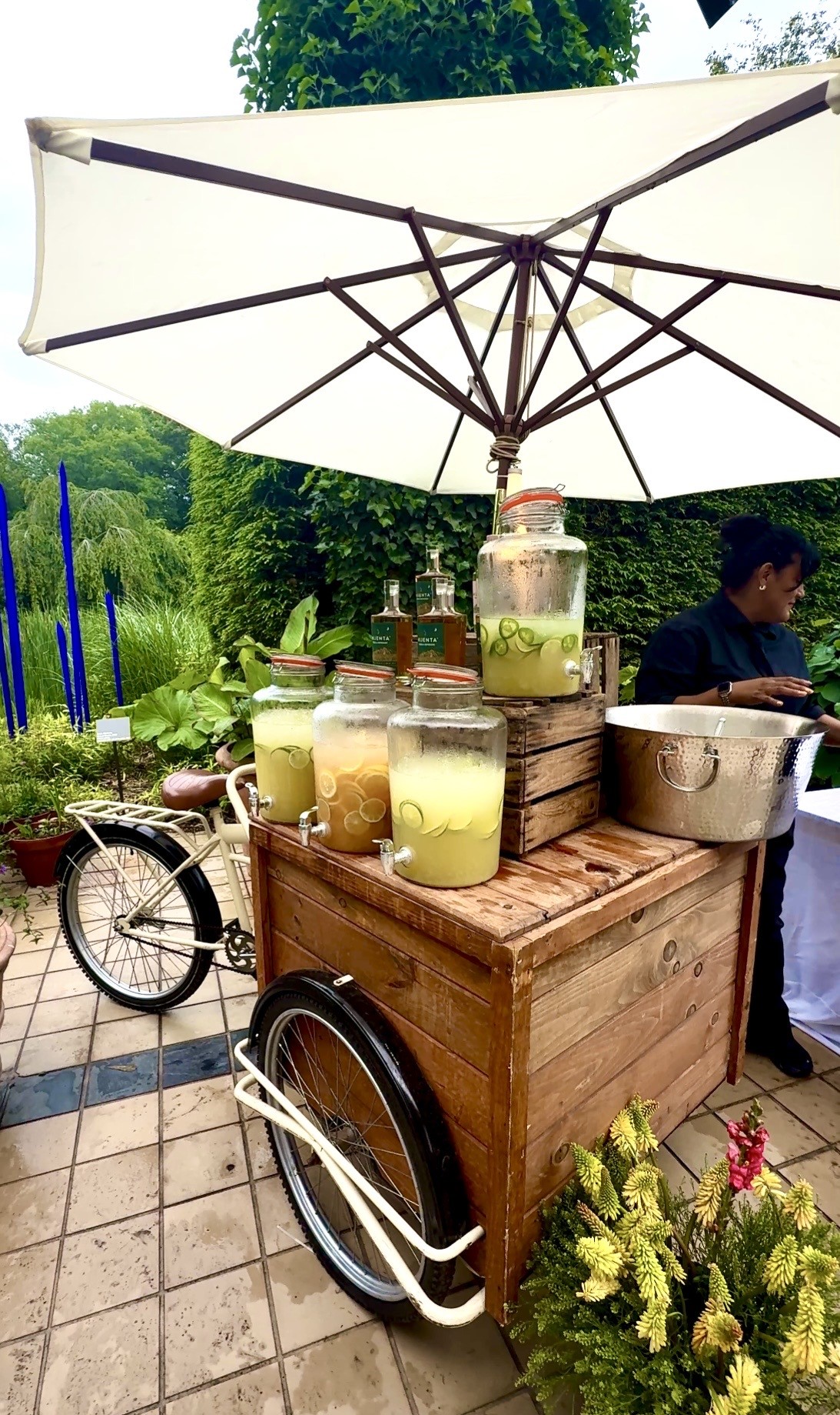 Wooden lemonade cart under white umbrella