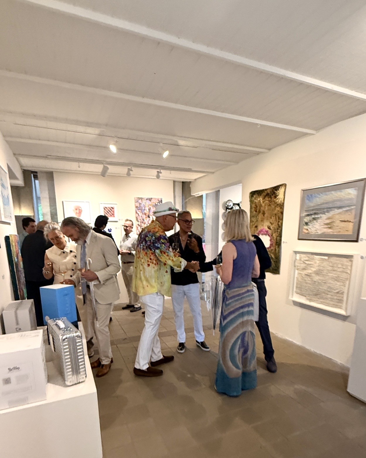 Visitors mingling at contemporary art exhibition