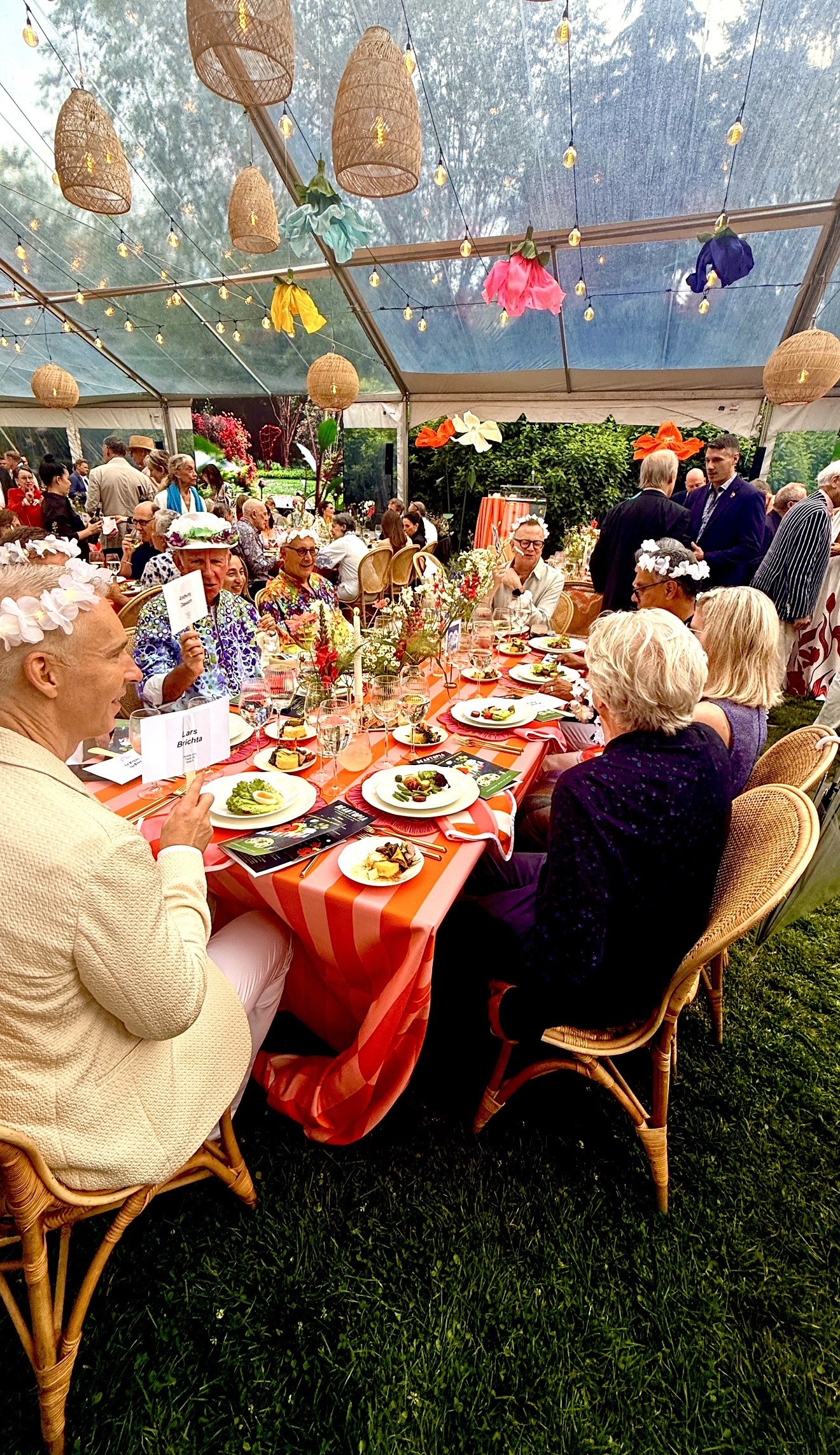 Guests enjoying colorful outdoor tented dinner