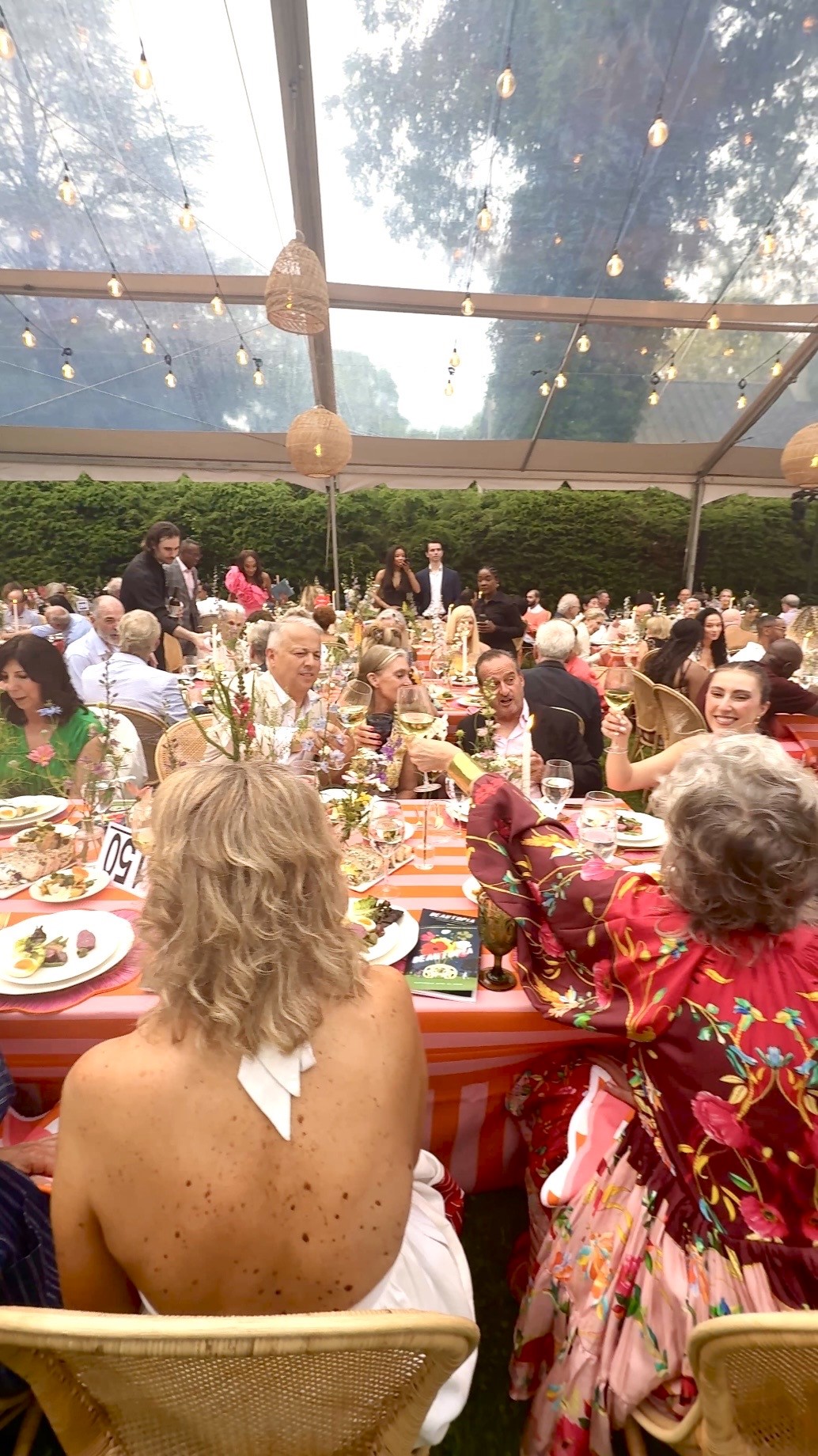 Guests dining at outdoor tented banquet